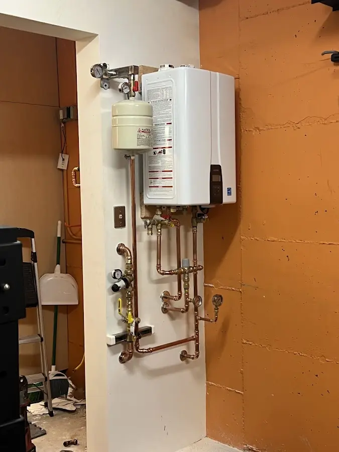 Plumbing technician inspecting water heater connections in Cascade